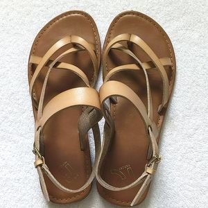 Tan sandals. Cross straps and buckle.